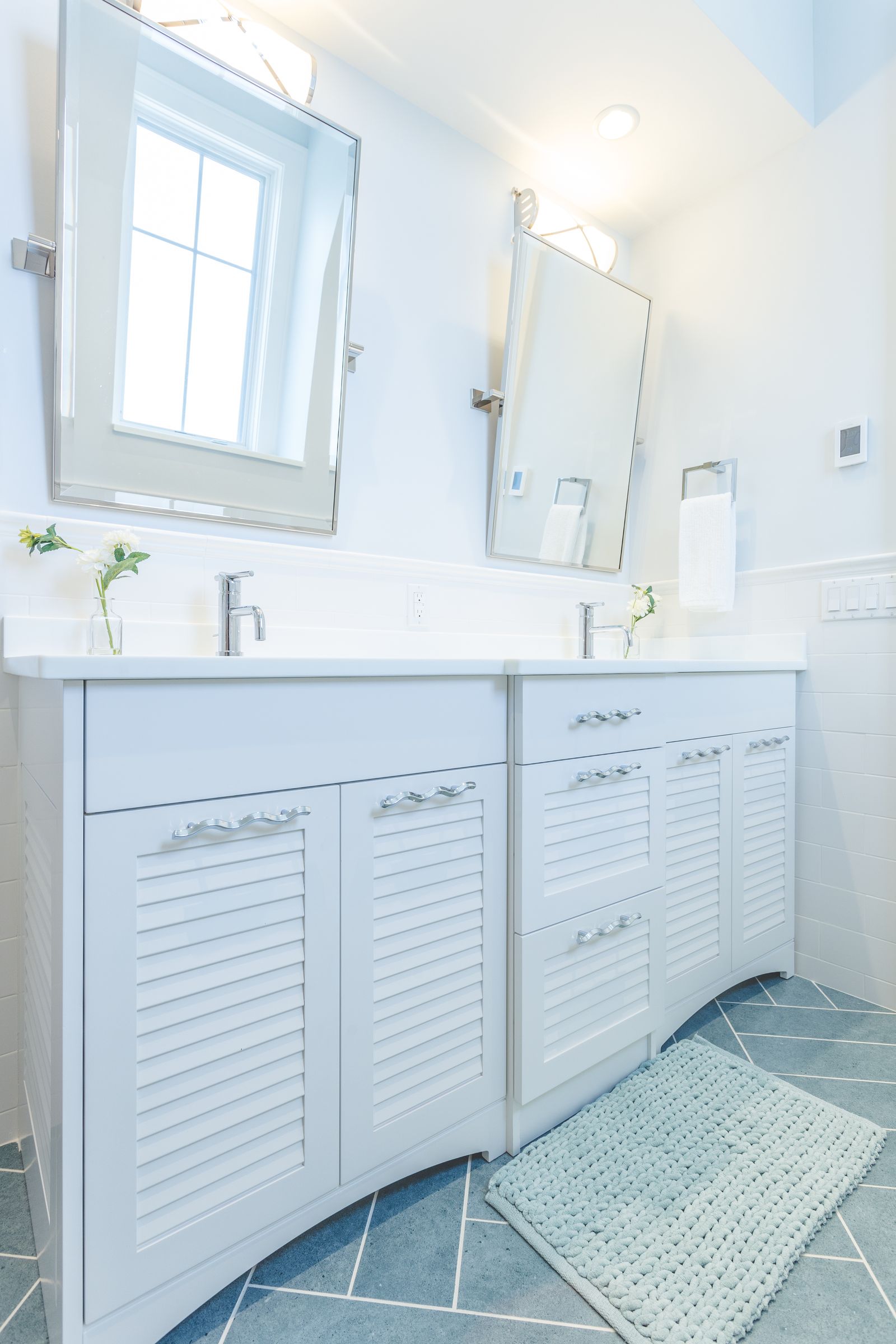 White double bathroom vanity with louvered doors built by Division Seven Millwork