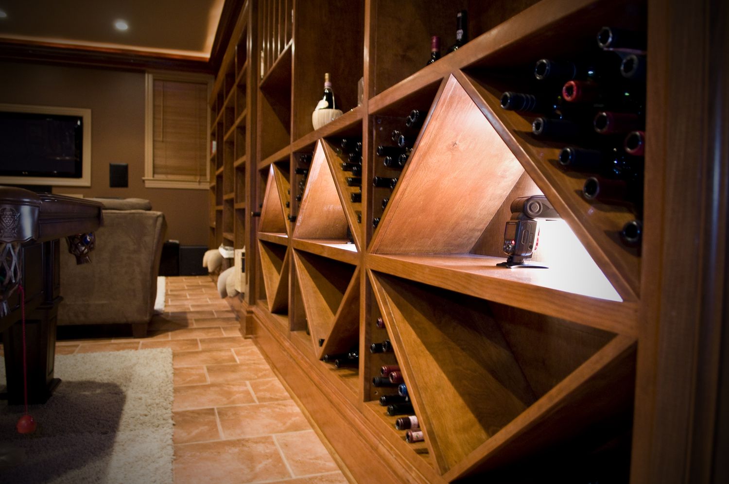 Custom wine cellar with diamond racks and tasting island built by Division Seven Millwork